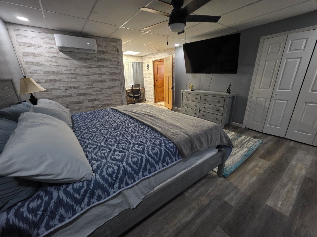 Master suite with smart TV and rustic decor in Morgantown Airbnb